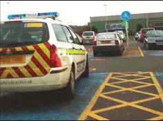 a picture of the police car parked in a disabled bay